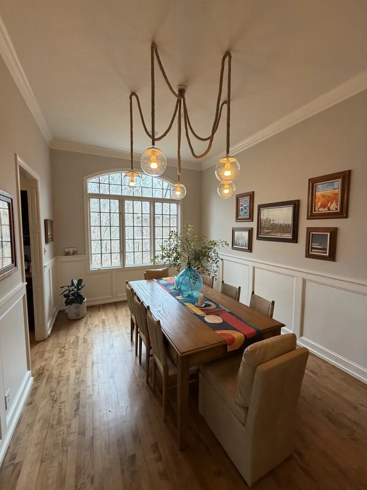 Multi-pendant swag chandelier installed by Wood and Wire over a family dining table