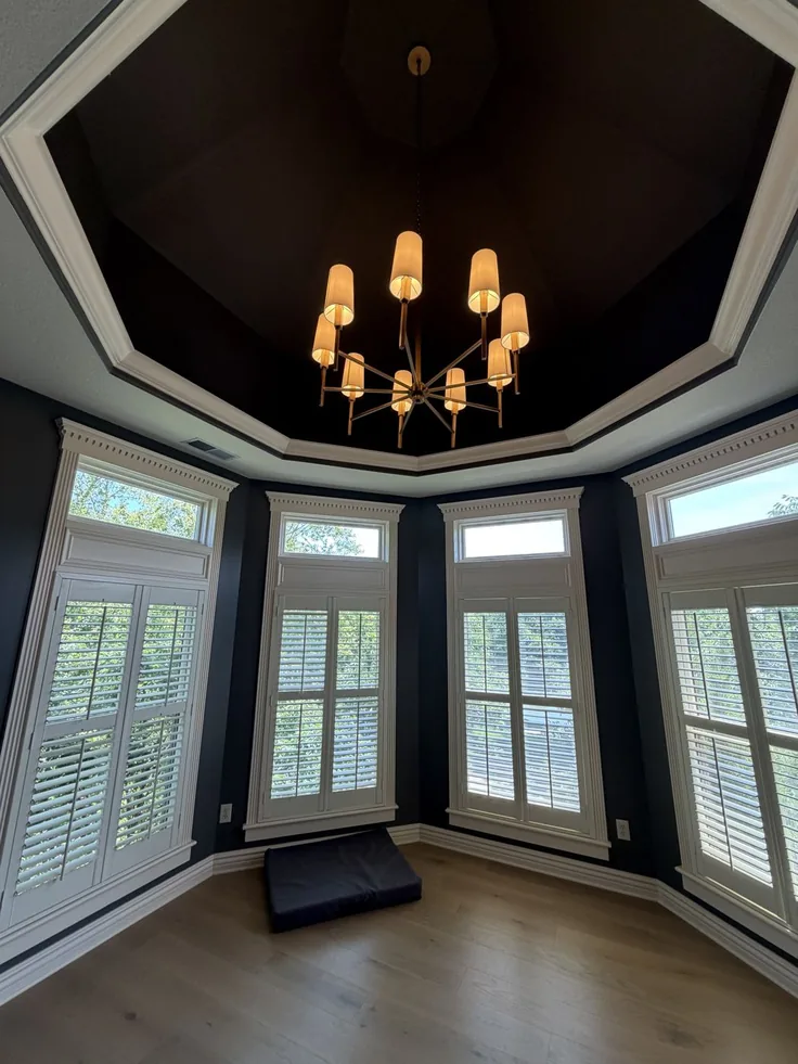 Statement chandelier installed in a turret window room